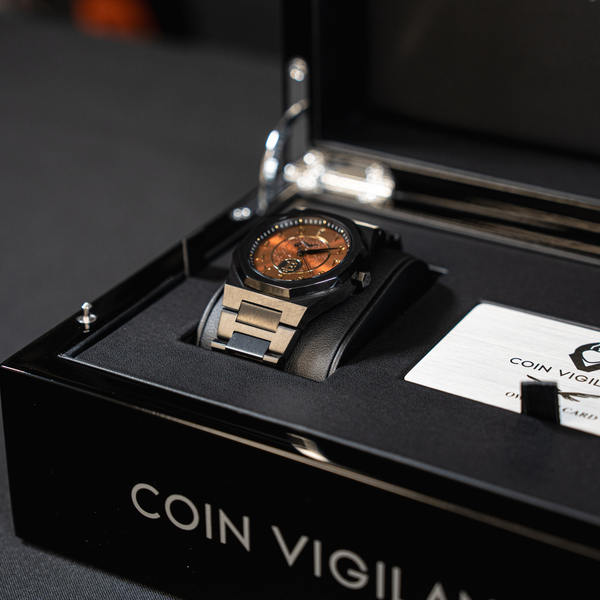 Coin Vigilante watch with a copper dial displayed in a branded presentation box